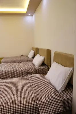 two beds sitting next to each other in a room at Petra Mountain House in Wadi Musa