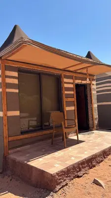 a chair sitting on a porch of a house at altair luxury rum in Wadi Rum