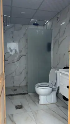 a bathroom with a toilet and a shower at altair luxury rum in Wadi Rum