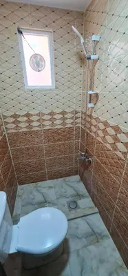 a bathroom with a toilet and a shower at Nabateans Home Hotel in Wadi Musa