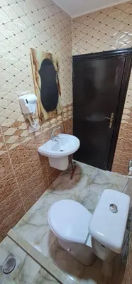 a bathroom with two toilets and a sink at Nabateans Home Hotel in Wadi Musa