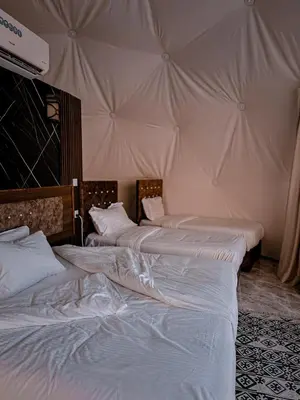 two beds sitting next to each other in a room at rum fun luxury camp in Wadi Rum