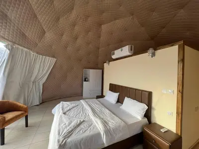 a bedroom with a bed with a wooden ceiling at Maestro camp Wadi Rum in Wadi Rum