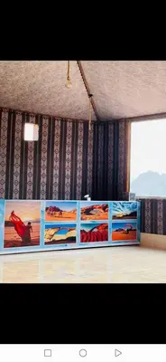 a room with four pictures on the wall at Maestro camp Wadi Rum in Wadi Rum