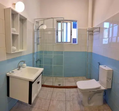 a bathroom with a toilet and a sink and a shower at Byblos Aqaba in Aqaba