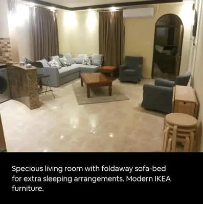 a living room with a couch and a table at Khirfan Crown Houses -downtown in Amman