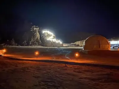 a night view of a beach with a domed building at Star rum in Wadi Rum