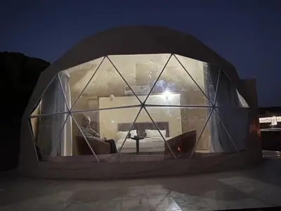 a man sitting in a round room with a window at Star rum in Wadi Rum