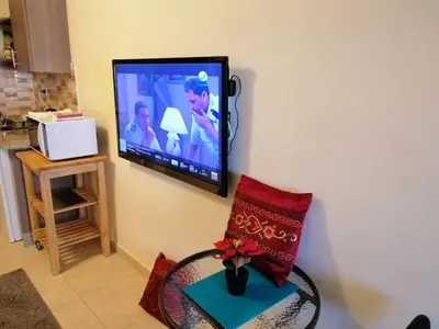 a living room with a tv on the wall at Abdoun studio in Amman