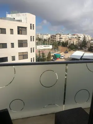 a balcony with a view of a city at Abdoun studio in Amman