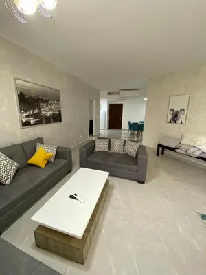 a living room with two couches and a coffee table at Tala bay apartments 2 bedroom for family only in Aqaba