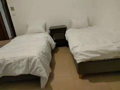 two beds sitting next to each other in a room at Tala bay apartments 2 bedroom for family only in Aqaba