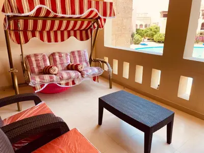 a living room with a couch and a table and a window at Tala bay apartments 2 bedroom for family only in Aqaba