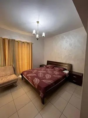 a bedroom with a bed and a chair in it at Nice tow bedrooms by snake pool for families only in Talapay in Aqaba