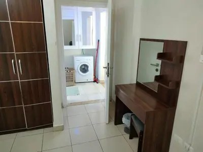 a bathroom with a mirror and a washing machine at Nice tow bedrooms by snake pool for families only in Talapay in Aqaba