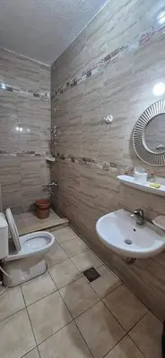 a bathroom with a toilet and a sink at Abo Amer Apartments in Aqaba