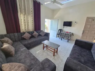 a living room with a couch and a table at Abo Amer Apartments in Aqaba