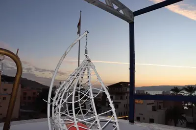 a white rope swing hanging from a balcony at Golden View in Aqaba