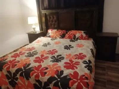 a bedroom with a bed with a flowery bedspread at The Stunning View in Wadi Musa