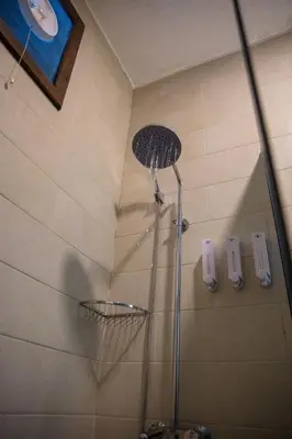 a shower with a shower head in a bathroom at Petra Seasons luxury Resort in Al Ḩayy