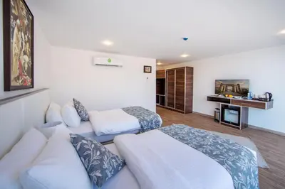 a room with a couch and a bed and a desk at Petra Seasons luxury Resort in Al Ḩayy
