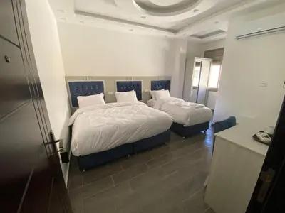 a bedroom with two beds in a room at Treasury Terrace Apartments in Wadi Musa