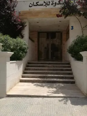 a set of stairs leading to a building at Dream Home in Amman
