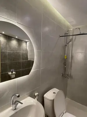 a bathroom with a toilet and a sink and a shower at RoadHouse - Petra in Wadi Musa