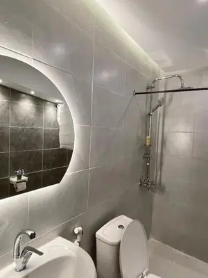 a bathroom with a white toilet and a sink at RoadHouse - Petra in Wadi Musa