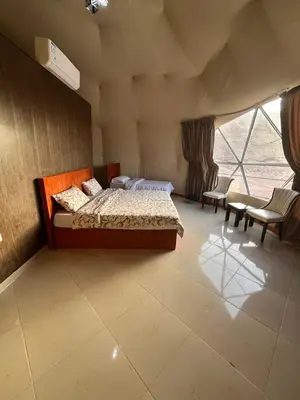 a bedroom with two beds and a large window at Al Raha Luxury Camp in Wadi Rum