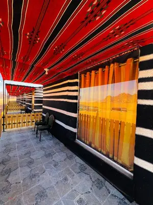 a room with a red and yellow striped wall at RUM ARJAAN lUXURY CAMP in Wadi Rum