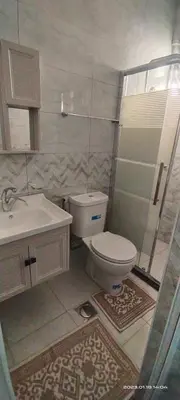 a bathroom with a toilet and a sink and a shower at Happy Beach For Studio Rooms Apartment شاطئ السعادة للشقق المفروشة in Aqaba