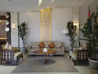 a living room with a couch and a table and chairs at H Luxury Hotel in Wadi Musa