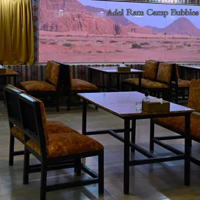 a table and chairs with a view of the grand canyon at Adel Wadi Rum Camp Bubble in Wadi Rum