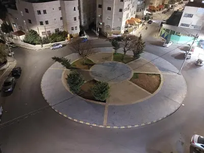 an aerial view of a park in the middle of a street at Cozy Home 2 in Amman