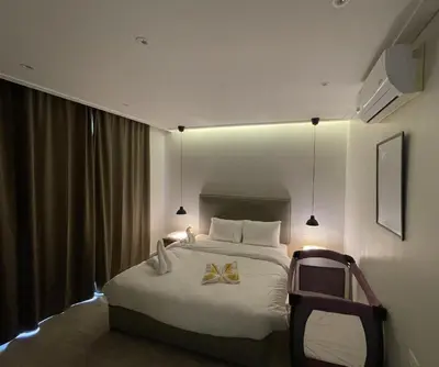 a hotel room with a bed with a bow on it at Zerø Føur DeadSea in Sowayma