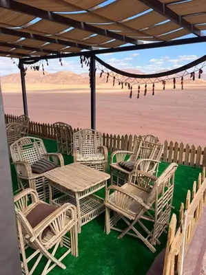 a group of chairs and tables on the beach at wadi rum Golden Sand in Wadi Rum
