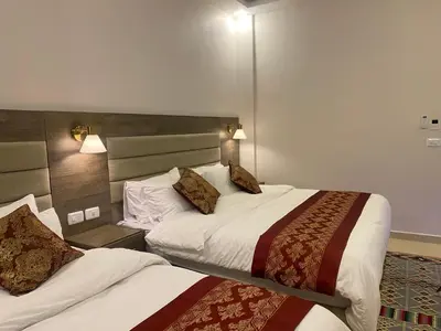 a hotel room with two beds in a room at Petra Oleander Hotel in Wadi Musa
