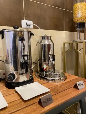 a kitchen counter with a coffee maker on it at Petra Oleander Hotel in Wadi Musa