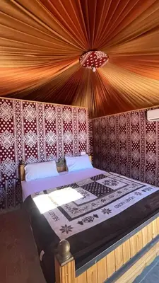 a bedroom with a bed in a tent at غرووب وادي رم in Wadi Rum