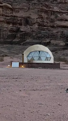 a building in the middle of a desert at Rum New Luxury Camp in Wadi Rum