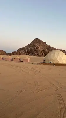 a tent in the desert with a mountain in the background at Rum New Luxury Camp in Wadi Rum