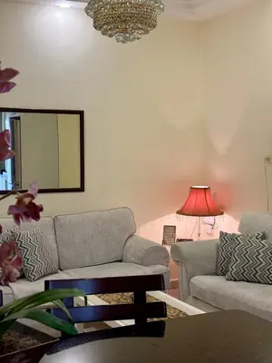a living room with a couch and a table at Exquisite & inviting 2 Bedroom 2 bath Balcony Fast internet in Amman