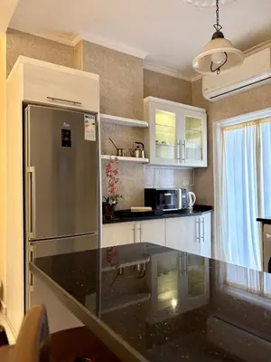 a kitchen with a refrigerator and a counter top at Exquisite & inviting 2 Bedroom 2 bath Balcony Fast internet in Amman