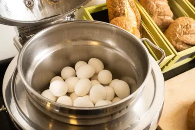 a bunch of eggs in a pot on a stove at Dweik Hotel LUXURY 3 in Aqaba