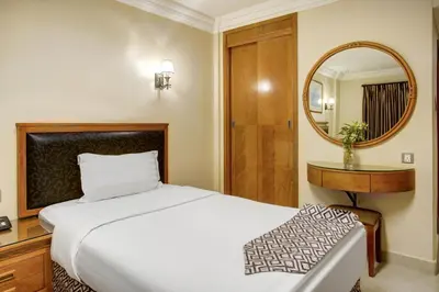 a bedroom with a bed and a mirror at Dweik Hotel LUXURY 3 in Aqaba
