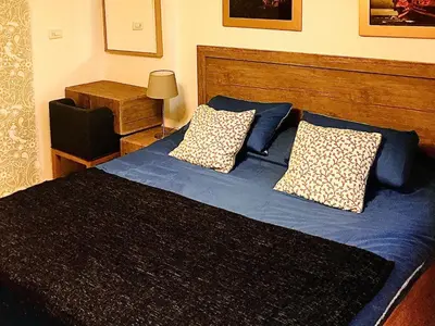 a bedroom with a bed with blue sheets and pillows at The Royal Luxury Queen Terrace 1 in Amman