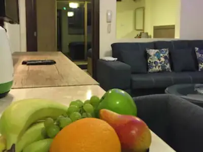 a plate of fruit on a table in a living room at The Royal Luxury Queen Terrace 1 in Amman
