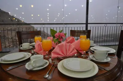 a wooden table with plates and glasses of orange juice at The RN Hotels in Wadi Musa