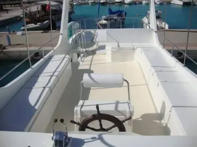 a chair on a boat in the water at The Royal Luxury Lion Patio in Amman